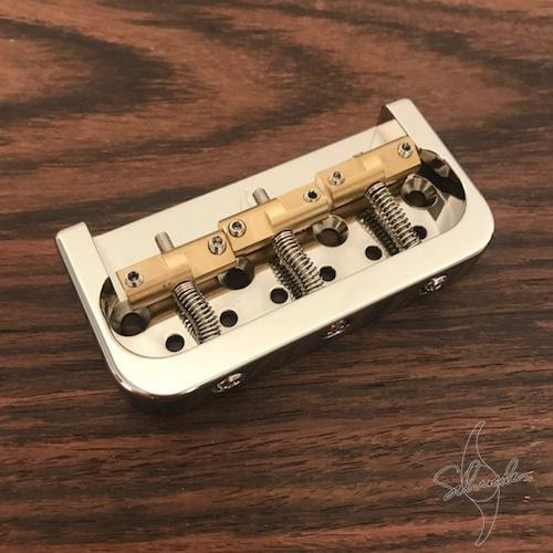 Schroeder Want a humbucker or P90 or a Filtertron pickup in the bridge of your Tele?  No problem.  The Schroeder TL Straight-Back Half Bridge is the more traditional version of our popular original Schroeder TL Half Bridge.  Both are an excellent replacement for tele style bridges, or for use on custom instruments with a non-standard bridge pickup. The aluminum and brass construction provides warm, clear and bell like tone transfer from strings to the body of your guitar. The TL Half-Bridge is intended for use with string-through-body construction and either string ferrules or a ball end plate on the back of the guitar body.  Quality materials and construction: Lightweight aluminum body and brass barrels.  String spacing: 2.125" (2 1/8")  Proudly milled in the USA.